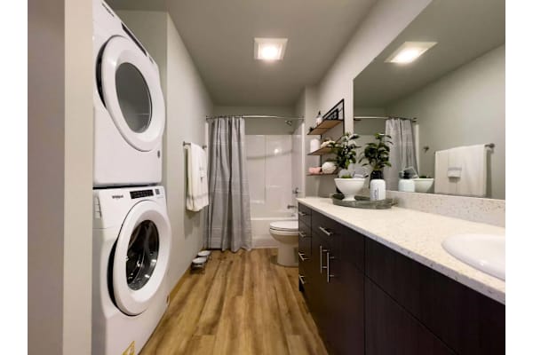 A small bathroom with a washing machine built into the wall.